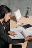 Businesswoman in an office reviewing documents with concentration and focus.